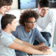 Apprentices around computer