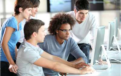 Apprentices around computer