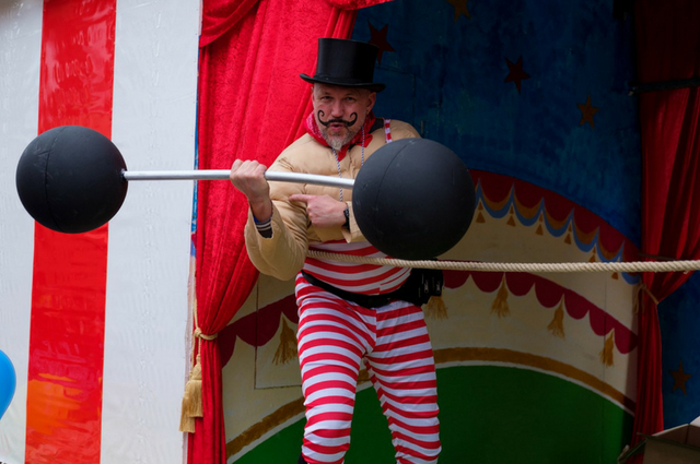 A man weightlifting at the circus