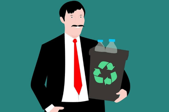 Picture of an office worker holding a recycling bin with plastic bottles