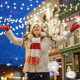 A picture of a lady starring in a christmas video outside in the street