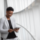 Photo of a business woman holding a tablet liaising with clients