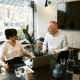 Image of two business people sharing workspace in a shared office