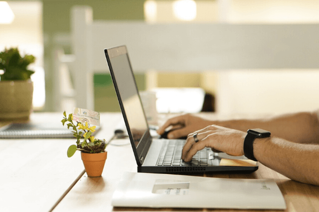 Image of a man working at his laptop in a flexible workspace