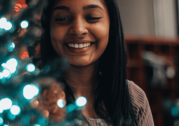 Picture of a female offie working sitting near a Christmas tree