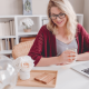 Woman working happily from her laptop at home