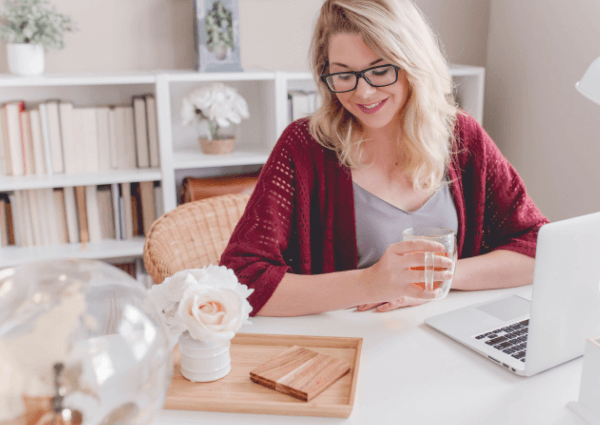 Woman working happily from her laptop at home