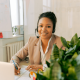 Picture of a female customer service rep on the phone and smiling