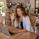 Picture of a woman smiling and waving on a networking video conferencing call