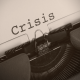 An image of an old vintage typewriter with written word crisis