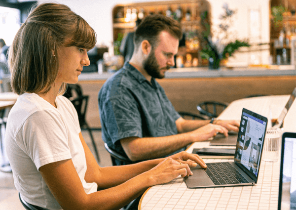 Pictures of two coworkers working from a hybrid location