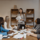 Image of a business team seated at the board table discussing strategy