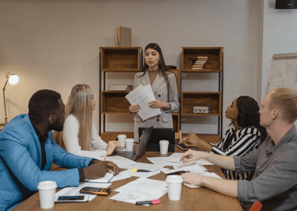 Image of a business team seated at the board table discussing strategy