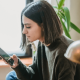 Image of a woman holding her phone checking social media