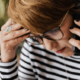 An image showing a business woman on the phone looking concerned