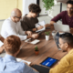 Picture of a team gathered around a table having a meeting
