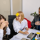 Colleagues at work playing a game with notes stuck to their foreheads