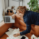 Picture of a female homeworker slouched on the couch with her laptop