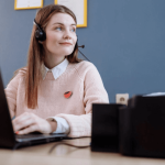 A business woman sitting in front of your laptop wearing a microphone